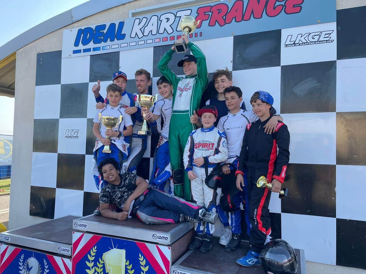 Les jeunes pilotes coachés par la School fêtent leurs coupes sur le podium d'une course Ideal Kart France